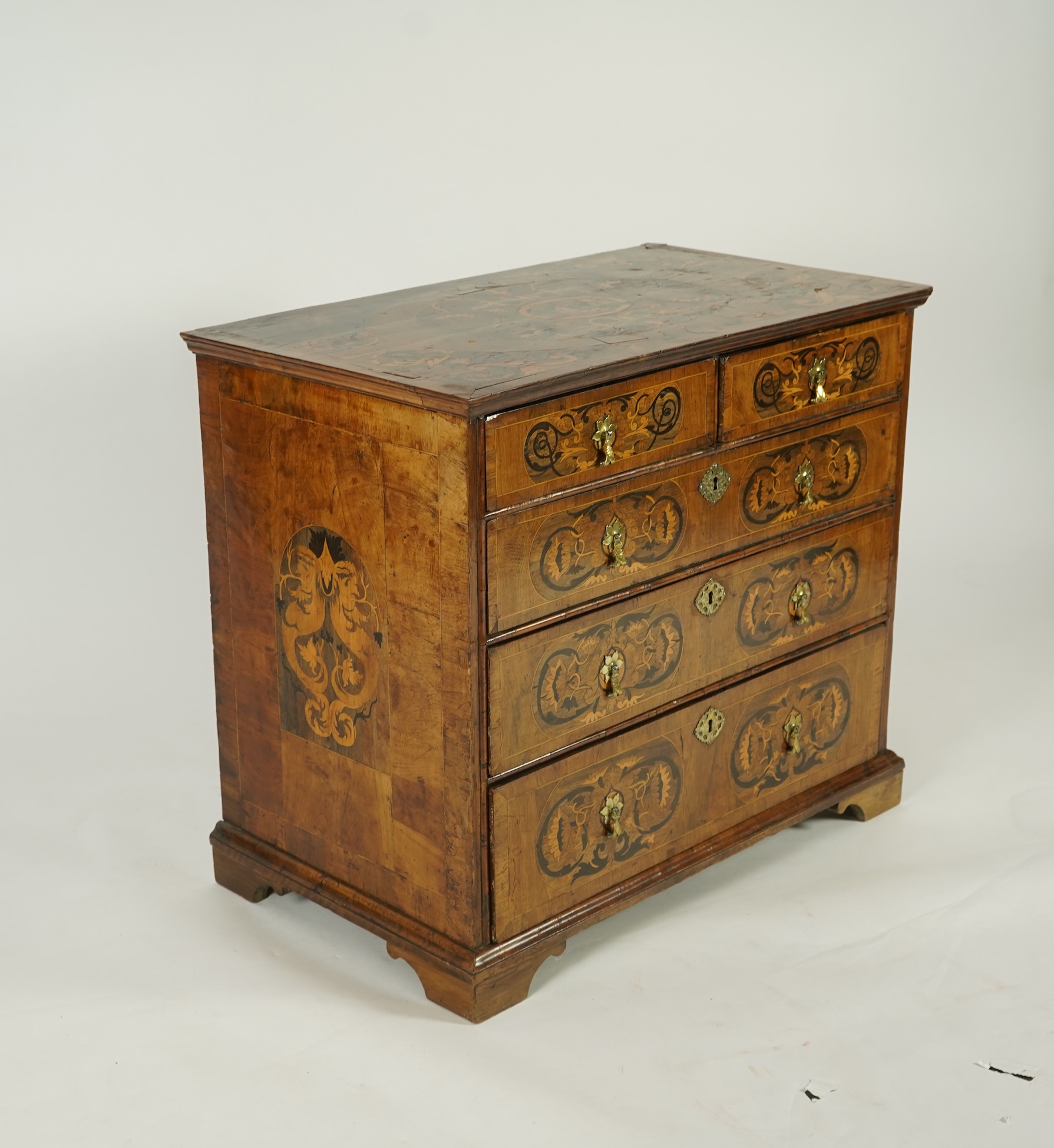 A William and Mary walnut and floral marquetry chest on later bracket feet